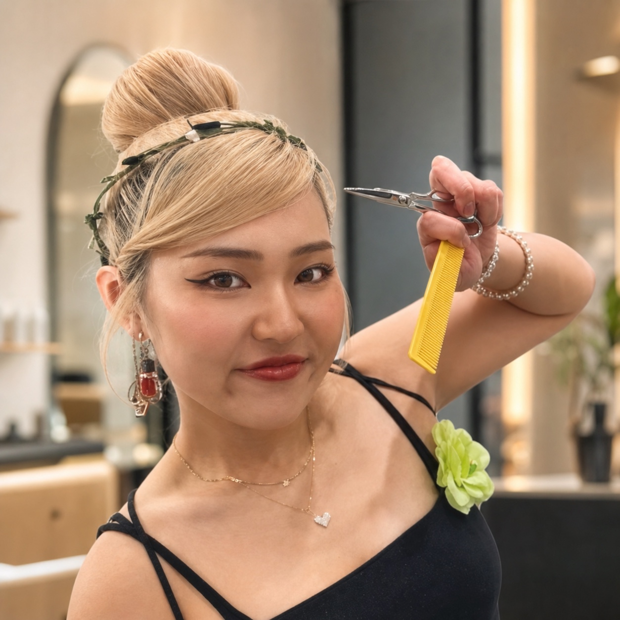 Shizuru, stylist at Lift Hair Studio, holding scissors and a comb
